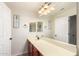 Bathroom featuring a long vanity, large mirror, and decorative nautical themed artwork at 21605 S 187Th Way, Queen Creek, AZ 85142