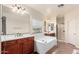 Bathroom featuring double sinks, a soaking tub, and a separate shower at 21605 S 187Th Way, Queen Creek, AZ 85142