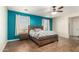 Bedroom displays stylish teal accent wall, wood floors and natural light at 21605 S 187Th Way, Queen Creek, AZ 85142
