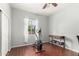 Bright bedroom with an elliptical exercise machine, desk and wood-look laminate flooring at 21605 S 187Th Way, Queen Creek, AZ 85142