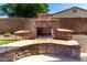 Outdoor fireplace featuring a stone hearth and seating area, perfect for cozy evenings and entertaining guests at 21605 S 187Th Way, Queen Creek, AZ 85142