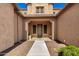 Covered front entry showcases a stylish door and convenient access to the home at 21605 S 187Th Way, Queen Creek, AZ 85142