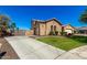 View of home highlighting the well-maintained lawn and extended driveway with wood gates at 21605 S 187Th Way, Queen Creek, AZ 85142