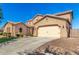 A two-car garage attached to the home, with a driveway and low maintenance front yard at 21605 S 187Th Way, Queen Creek, AZ 85142