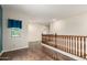 Upstairs landing area boasts wood floors and a wooden railing at 21605 S 187Th Way, Queen Creek, AZ 85142
