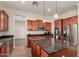Beautiful kitchen has stainless steel appliances, a granite-topped island and wood cabinetry at 21605 S 187Th Way, Queen Creek, AZ 85142