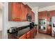 The kitchen has sleek stainless steel appliances, and dark granite countertops at 21605 S 187Th Way, Queen Creek, AZ 85142