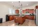 Well-lit kitchen showcases dark granite countertops, stainless steel appliances and kitchen island at 21605 S 187Th Way, Queen Creek, AZ 85142
