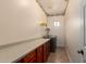 Spacious laundry room features ample counter space, shelving and tile floors at 21605 S 187Th Way, Queen Creek, AZ 85142