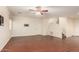 Inviting living room boasts wood-look floors, a ceiling fan, and mountings for TV at 21605 S 187Th Way, Queen Creek, AZ 85142