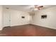 Spacious living room with wood-look floors, ceiling fan and mountings for TV at 21605 S 187Th Way, Queen Creek, AZ 85142
