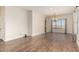 Spacious, bright living room with wood floors, a large window, and elegant chandelier at 21605 S 187Th Way, Queen Creek, AZ 85142