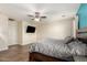 Main bedroom features wood floors, a ceiling fan, and neutral paint at 21605 S 187Th Way, Queen Creek, AZ 85142