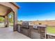 Outdoor kitchen features a built-in grill, mini-fridge, and countertop space for food preparation and serving at 21605 S 187Th Way, Queen Creek, AZ 85142