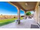 Covered patio with ceiling fan, outdoor dining, built-in BBQ and landscaped yard at 21605 S 187Th Way, Queen Creek, AZ 85142
