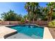 Inviting swimming pool with a waterfall feature and lush tropical landscaping, creating a perfect backyard oasis at 21605 S 187Th Way, Queen Creek, AZ 85142
