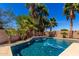 Swimming pool with water feature and surrounding palm trees, creating a relaxing and private outdoor oasis at 21605 S 187Th Way, Queen Creek, AZ 85142