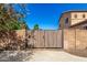 A view of a wood gate on a property in front of blue skies at 21605 S 187Th Way, Queen Creek, AZ 85142