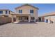 Large backyard featuring a covered patio area ideal for outdoor relaxation at 22328 W Woodlands Ave, Buckeye, AZ 85326