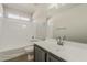 Bathroom featuring a shower-tub combo, modern vanity, and a neutral color scheme at 22328 W Woodlands Ave, Buckeye, AZ 85326