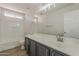 Bright bathroom showcasing a vanity with double sinks, a tub-shower, and a toilet at 22328 W Woodlands Ave, Buckeye, AZ 85326
