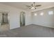 Spacious bedroom with attached entry to hallway and ensuite bathroom, featuring neutral tones and natural light at 22328 W Woodlands Ave, Buckeye, AZ 85326