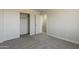 Bedroom featuring neutral carpet and a closet with bi-fold doors at 22328 W Woodlands Ave, Buckeye, AZ 85326