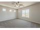 Bright and airy bedroom featuring a large window with views and neutral walls with plush carpeting at 22328 W Woodlands Ave, Buckeye, AZ 85326