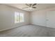 Serene bedroom features neutral tones, large window bringing natural light, and attached closet at 22328 W Woodlands Ave, Buckeye, AZ 85326