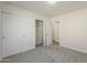 Bright bedroom featuring double closets, neutral carpet, and white walls at 22328 W Woodlands Ave, Buckeye, AZ 85326
