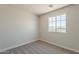 Bedroom featuring neutral carpet and a window with neighborhood views at 22328 W Woodlands Ave, Buckeye, AZ 85326