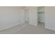 Neutral bedroom featuring carpet, closet, and white doors creating a serene and inviting space at 22328 W Woodlands Ave, Buckeye, AZ 85326