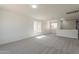 Bright bonus room featuring modern lighting, carpet, and light paint color at 22328 W Woodlands Ave, Buckeye, AZ 85326