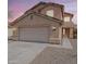 Charming two-story home featuring a neutral color palette, a two-car garage, and a well-maintained front yard at 22328 W Woodlands Ave, Buckeye, AZ 85326