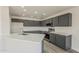 Bright kitchen features stainless steel appliances, ample storage, and a spacious island with countertop seating at 22328 W Woodlands Ave, Buckeye, AZ 85326