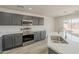 This kitchen boasts sleek stainless steel appliances, modern gray cabinetry, and ample counter space at 22328 W Woodlands Ave, Buckeye, AZ 85326