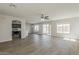 Spacious living room with ceiling fan, light wood floors and an open floor plan at 22328 W Woodlands Ave, Buckeye, AZ 85326