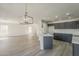 Open concept living space with modern chandelier and kitchen, filled with natural light at 22328 W Woodlands Ave, Buckeye, AZ 85326