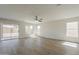 Bright and spacious living area with modern ceiling fan, sliding glass doors and natural light at 22328 W Woodlands Ave, Buckeye, AZ 85326