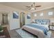 Relaxing primary bedroom with a calming blue color scheme, decorative art, and lots of natural light at 22328 W Woodlands Ave, Buckeye, AZ 85326