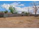 Fenced backyard features mature trees and a grill at 2425 W Shady Glen Ave, Phoenix, AZ 85023