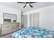 Bright bedroom features a ceiling fan, closet, and ample natural light at 2425 W Shady Glen Ave, Phoenix, AZ 85023