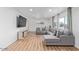 Bright living room with modern flooring, neutral walls, and a comfortable gray sectional couch at 2425 W Shady Glen Ave, Phoenix, AZ 85023