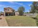Large backyard with lush green grass, a covered patio, and a privacy fence at 25409 N 40Th Ln, Phoenix, AZ 85083
