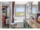 Relaxing primary bathroom featuring a soaking tub with window views, neutral color palette, and granite countertops at 25409 N 40Th Ln, Phoenix, AZ 85083