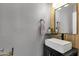 Modern half-bath with a floating vanity, vessel sink, and rustic wood-look accents at 25409 N 40Th Ln, Phoenix, AZ 85083