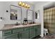 Bathroom featuring a double vanity, granite countertop, olive green cabinets, and a shower/tub combo at 25409 N 40Th Ln, Phoenix, AZ 85083