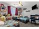 bedroom featuring twin beds with 'Cars' themed bedding, a desk, and plush stuffed animals at 25409 N 40Th Ln, Phoenix, AZ 85083