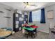 Bedroom featuring blue curtains, dark closet, multiple storage shelves, and a play table with chairs at 25409 N 40Th Ln, Phoenix, AZ 85083