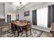 Spacious dining room with a large table, seating for ten, and a modern light fixture, adjacent to the stairs at 25409 N 40Th Ln, Phoenix, AZ 85083